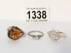 A yellow metal cluster ring and 2 others