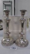 A pair of ornate silver plate candlesticks