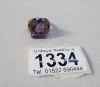 A 9ct gold ring set large purple stone