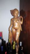 A large carved wood nude figure