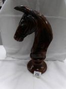 A carved wood horse head