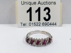A 14ct yellow gold ruby and diamond ring (baguettes and brilliants)