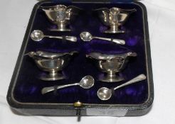 A cased set of 4 silver salts with spoons