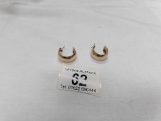 A pair of 9ct gold ear hoops