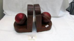 A pair of cricket ball bookends (balls from Middlesex cricket club,