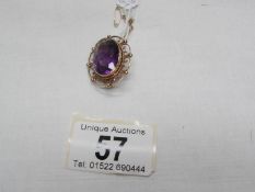 A vintage quality amethyst set brooch in gold with safety chain, total weight 8.