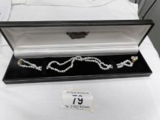 A pearl necklace with diamond and 18ct clasp and pendant drop
