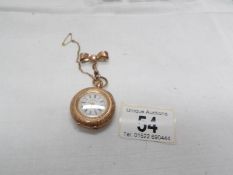 An early 19th century 14ct gold ladies fob watch in chased gold with enamel face surmounted by a