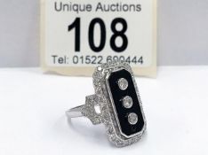 An 18ct white gold onyx and diamond ring,