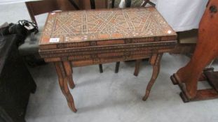 A marquetry inlaid games table