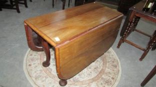 A mahogany drop leaf table