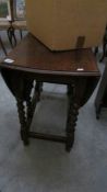 An oak gate leg table on barley twist supports