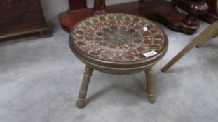 An Asian brass stool