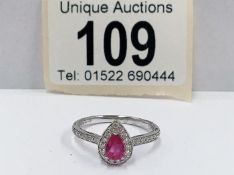 An 18ct white gold pear shaped ruby and diamond ring