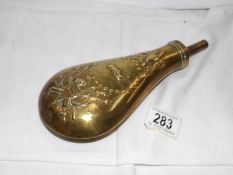 A brass gun powder flask