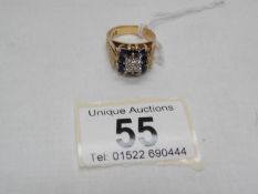 A diamond and sapphire in a square setting ring, dated Birmingham 1974, stamped TAD to inner shank,