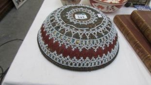 A decorative Asian bowl featuring bead work