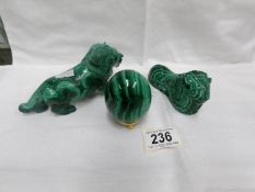 2 carved green stone lions and an egg on stand