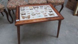 A coffee table inset with butterflies