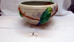 A Clarice Cliff bowl decorated with parrots in relief and marked Clarice Cliff, Newport Pottery.