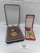 A replica USA defence medal and one other