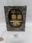 A metal framed gold plated insignia for USA navy seals team (rank Lt.