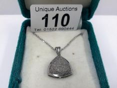 A white gold half carat diamond pendant on a 9ct white gold chain