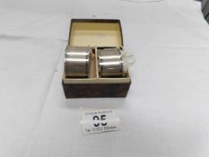 A cased pair of silver napkin rings