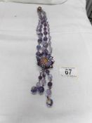 An outstanding 1940/50's double row crystal necklace with large pendant drop in shades of purple