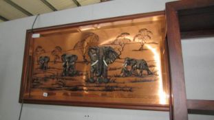A copper elephant plaque