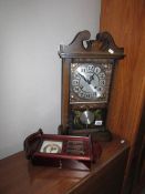 A mantel clock and a small wall clock