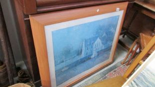 A large framed and glazed print of a river scene