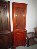 A glazed corner cabinet