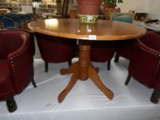 A circular centre pedestal dining table