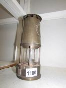 A miner's lamp with maker's plate 'Protector Lamp & Lighting Co., Ltd.