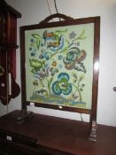 An oak framed fire screen with tapestry inset