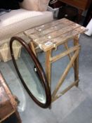 A oval bevel edged mirror and wooden step ladder