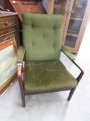 A green upholstered wooden armchair