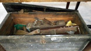 An old wooden chest and contents of vintage tools