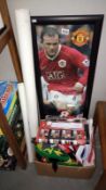 A collection of Manchester United football posters and scarves