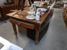 A pine kitchen table with end drawer