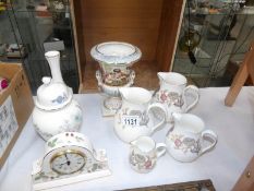 A set of 4 Wedgwood graduated jugs, a Wedgwood clock,