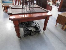 A Victorian mahogany table with 2 extra leaves