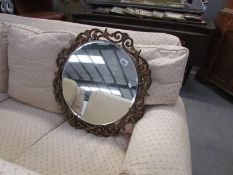 A round gilt framed mirror