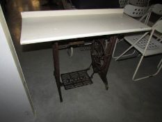 A Singer treadle sewing machine base made in to a table