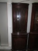 An astragal glazed corner cabinet