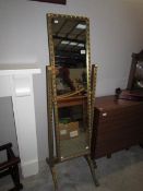 A gilt framed cheval mirror