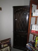 A good quality Priory style lead glazed oak corner cabinet