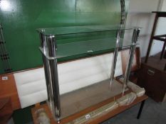 A set of chrome and glass shelves