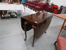 A mahogany pad foot drop leaf dining table